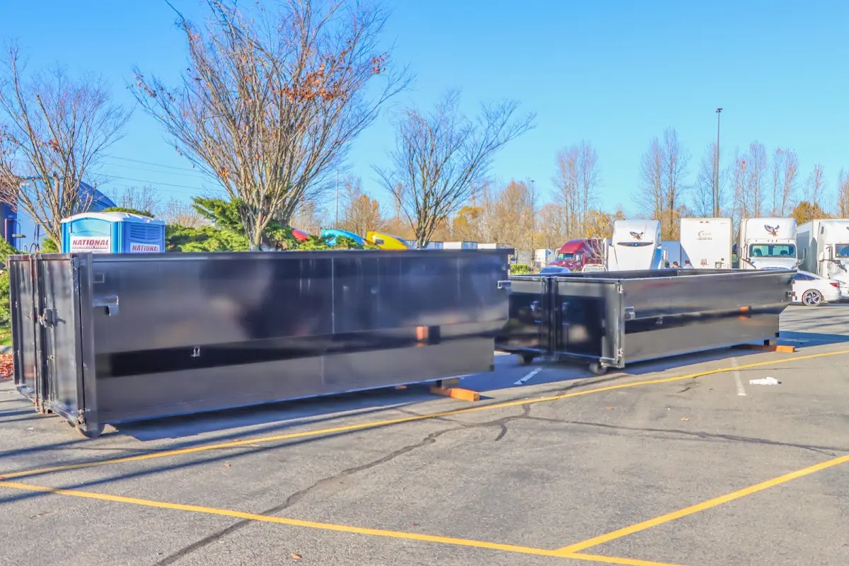 Professional dumpster rental service with roll-off container on residential driveway in Sparta